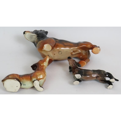 167 - A Beswick pottery Dachshund sausage dog 22cm long and two smaller similar pottery Dachshund dogs. (3... 