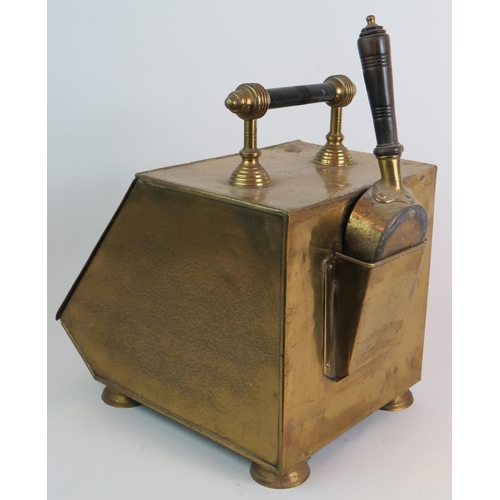 181 - A brass Edwardian coal scuttle and shovel with embossed lid and turned wood handles. Zinc liner incl... 