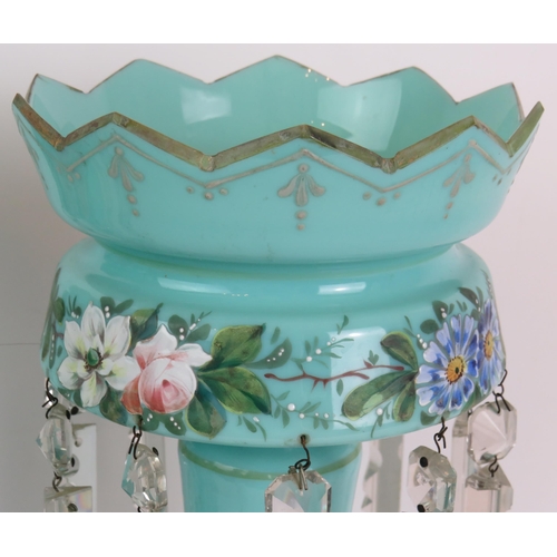 183 - A pair of late Victorian/Edwardian pale blue glass table lustre's hand decorated with a floral band ... 