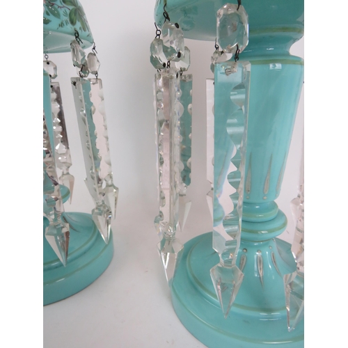 183 - A pair of late Victorian/Edwardian pale blue glass table lustre's hand decorated with a floral band ... 