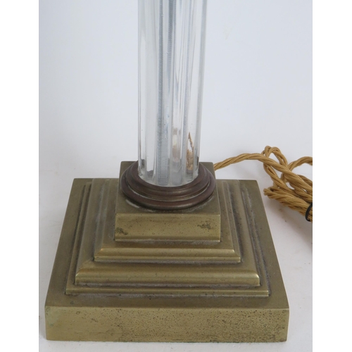 196 - A vintage brass and glass Corinthian column table lamp with reeded glass column. Height 49cm. Condit... 