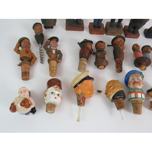 211 - A collection of mainly Black Forest style carved wood figures and bottle stoppers including automate... 