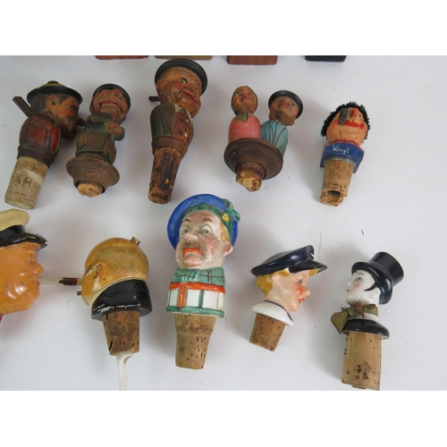 211 - A collection of mainly Black Forest style carved wood figures and bottle stoppers including automate... 