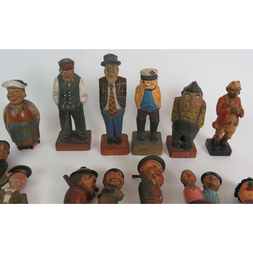 211 - A collection of mainly Black Forest style carved wood figures and bottle stoppers including automate... 