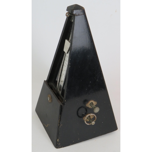 218 - A black Japanned Maelzel metronome with bell, dated 1965. Height 22cm.
Condition report: Feet missin... 