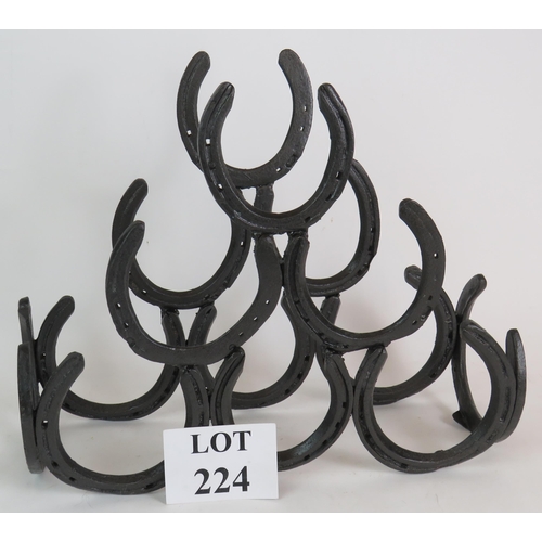 224 - A blacksmith made horseshoe six bottle wine rack made from real horseshoes. Height 36cm, width 45cm.... 