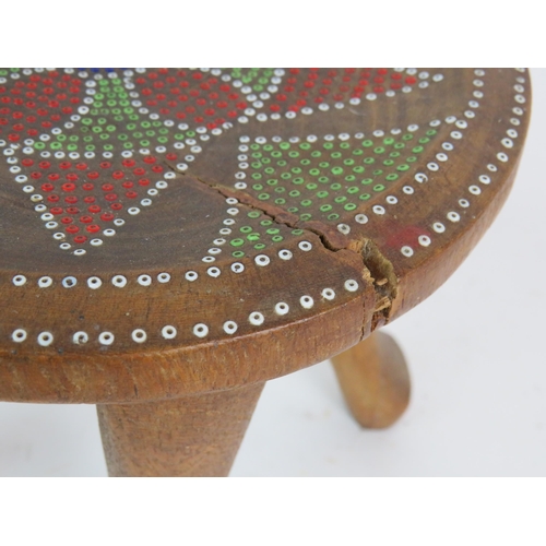 232 - A four legged carved wood ethnic stool with dot painted seat, probably Australian. Height 23cm, diam... 