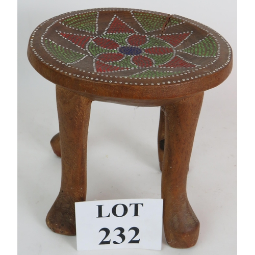 232 - A four legged carved wood ethnic stool with dot painted seat, probably Australian. Height 23cm, diam... 