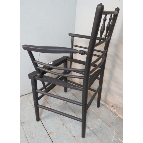 702 - A 19th century ebonised Sussex armchair in the manner of William Morris, in need of re-caning.
85cm ... 