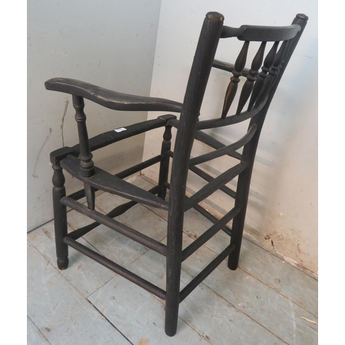 703 - A 19th century Sussex armchair in the manner of William Morris, in need of re-caning.
83cm high x 58... 