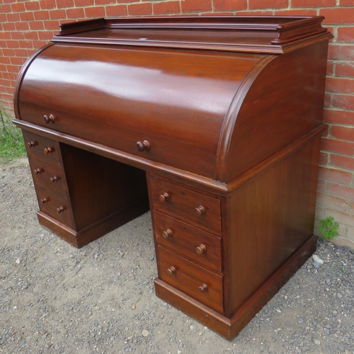 706 - A large late Victorian mahogany cylindrical desk, the fitted interior housing an array of satinwood ... 