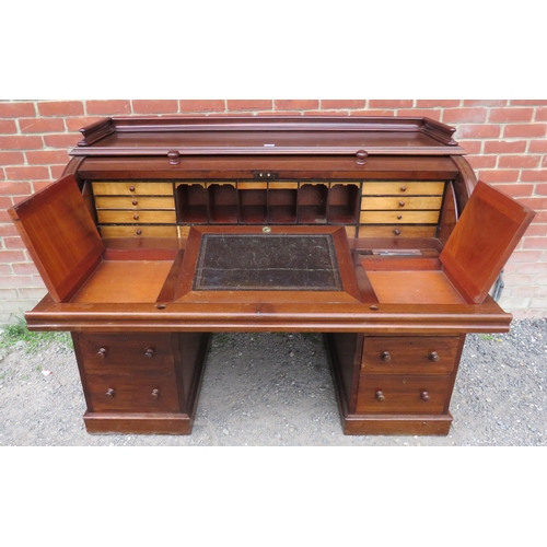 706 - A large late Victorian mahogany cylindrical desk, the fitted interior housing an array of satinwood ... 