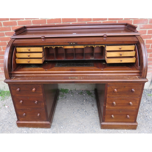 706 - A large late Victorian mahogany cylindrical desk, the fitted interior housing an array of satinwood ... 