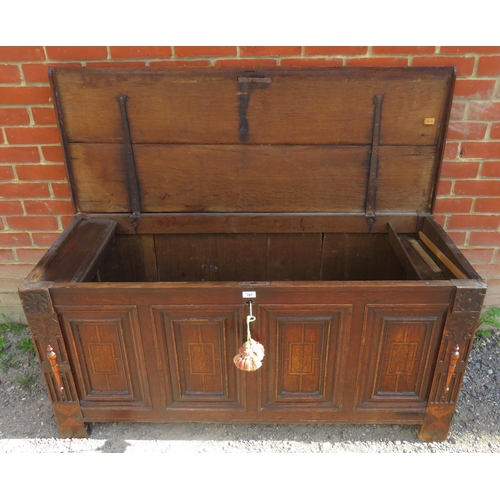 707 - An early 18th century oak coffer with twin candle boxes and marquetry inlaid fielded panels to front... 