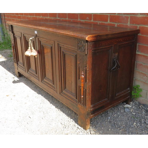 707 - An early 18th century oak coffer with twin candle boxes and marquetry inlaid fielded panels to front... 