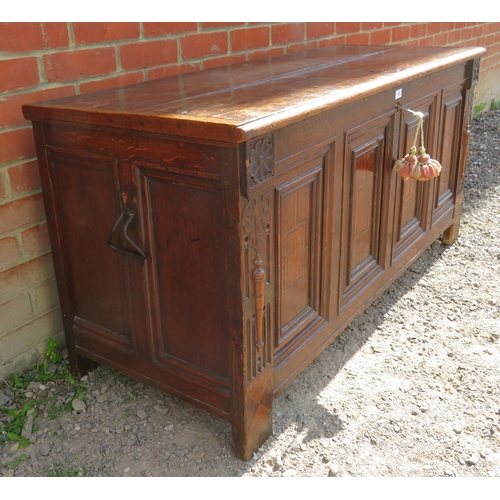 707 - An early 18th century oak coffer with twin candle boxes and marquetry inlaid fielded panels to front... 