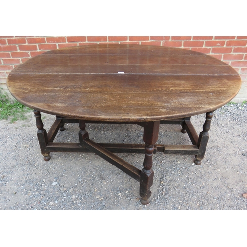 712 - A substantial early 18th century oak oval gateleg table with single drawer to one side raised on bal... 