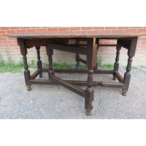 712 - A substantial early 18th century oak oval gateleg table with single drawer to one side raised on bal... 