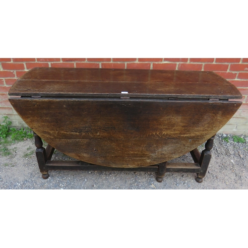 712 - A substantial early 18th century oak oval gateleg table with single drawer to one side raised on bal... 