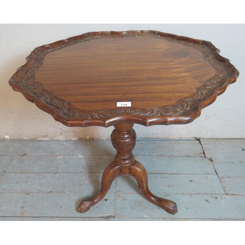 714 - A 19th century mahogany tilt top table with pie crust edge carved with acanthus leaves, raised on a ... 