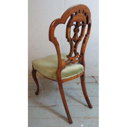 722 - A set of 6 Victorian walnut balloon back dining chairs, with carved and pierced back splats depictin... 