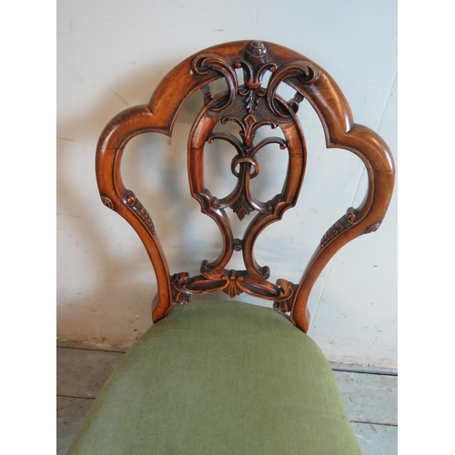 722 - A set of 6 Victorian walnut balloon back dining chairs, with carved and pierced back splats depictin... 