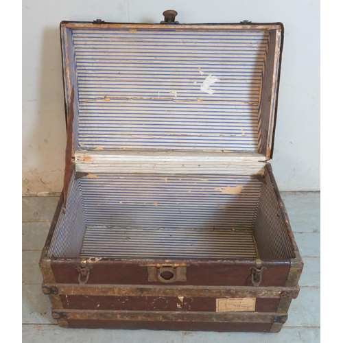 724 - A 19th century dome topped leather, wood & metal band travelling trunk, bearing various numerous his... 