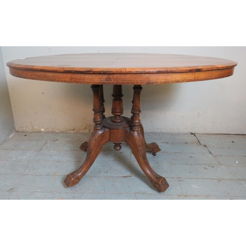 732 - A 19th century walnut tilt top oval breakfront table with quarter veneered top featuring geometric p... 