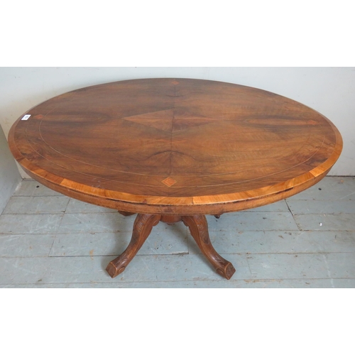 732 - A 19th century walnut tilt top oval breakfront table with quarter veneered top featuring geometric p... 