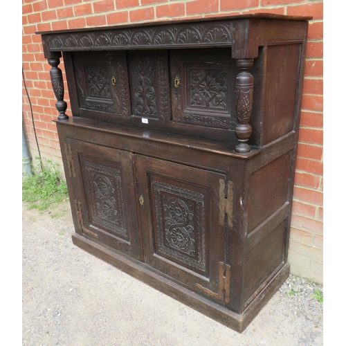 736 - An 18th century oak court cupboard of small proportions with carved frieze over two cupboard doors o... 