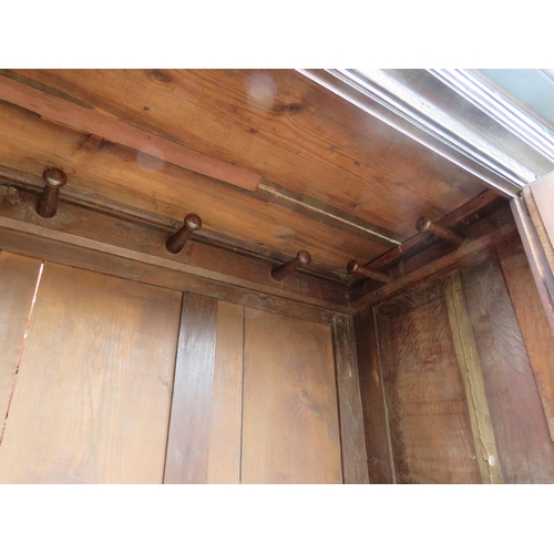 738 - An early 18th century oak wardrobe, the double doors with brass knobs & fielded panels, opening onto... 