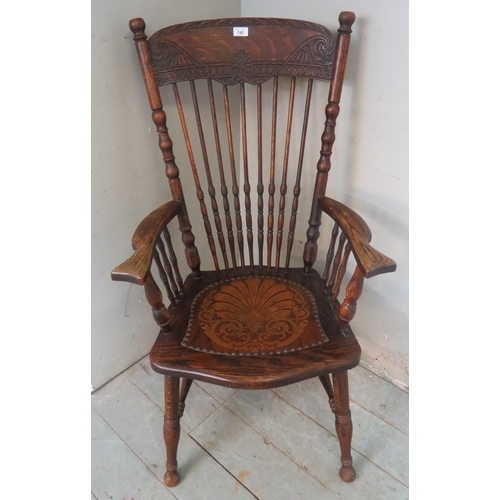 742 - A turn of the century oak fireside Windsor chair with ornate carved back splat & spurtle turned spin... 