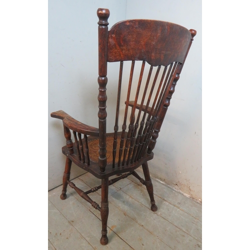 742 - A turn of the century oak fireside Windsor chair with ornate carved back splat & spurtle turned spin... 