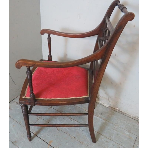 752 - An Edwardian mahogany open sided elbow chair boxwood strung with a crimson damask seat, raised on ri... 