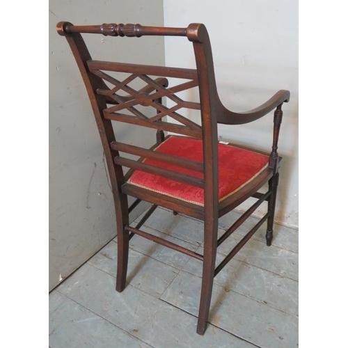 752 - An Edwardian mahogany open sided elbow chair boxwood strung with a crimson damask seat, raised on ri... 