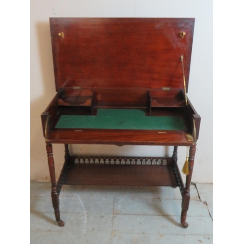 753 - An Edwardian mahogany writing desk with lockable raising lid opening to reveal letter racks & writin... 