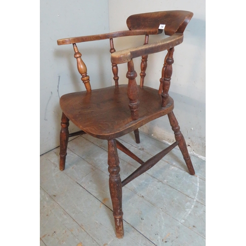 758 - A 19th century elm desk chair with spindle turned uprights raised on baluster turned supports united... 