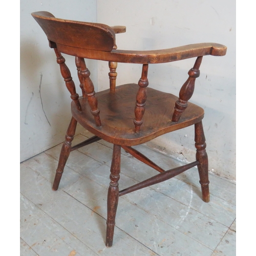 758 - A 19th century elm desk chair with spindle turned uprights raised on baluster turned supports united... 