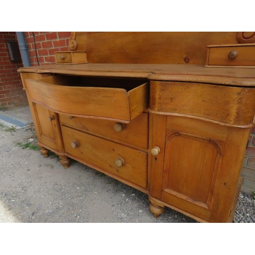 760 - An antique pine Lancashire dresser, the shaped back decorated with carved cornice & finials, over a ... 