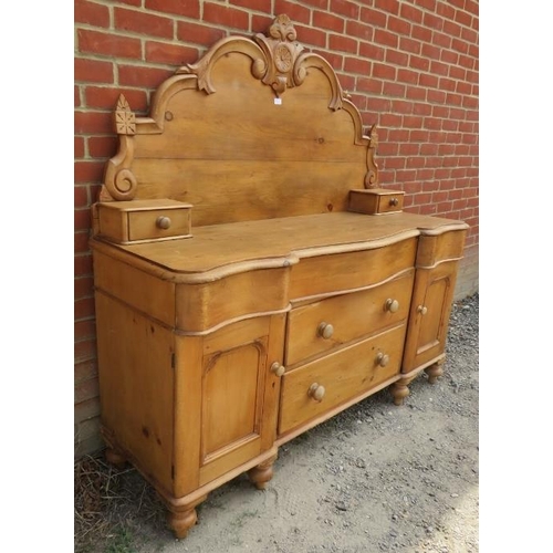 760 - An antique pine Lancashire dresser, the shaped back decorated with carved cornice & finials, over a ... 