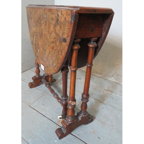 762 - A Victorian oval walnut Sutherland table strung with satinwood and raised on turned supports. 
53cm ... 