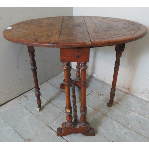 762 - A Victorian oval walnut Sutherland table strung with satinwood and raised on turned supports. 
53cm ... 