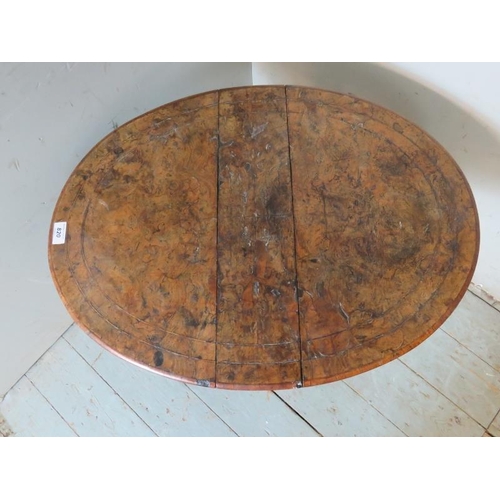 762 - A Victorian oval walnut Sutherland table strung with satinwood and raised on turned supports. 
53cm ... 