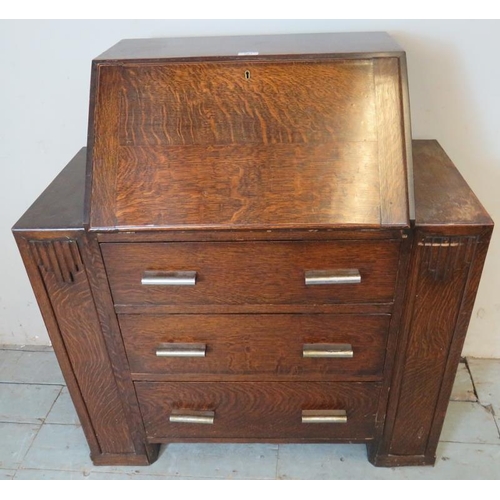 766 - An Art Deco bureau with fall front enclosing fitted interior, over three graduated long drawers with... 