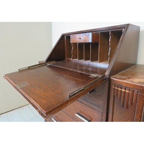 766 - An Art Deco bureau with fall front enclosing fitted interior, over three graduated long drawers with... 