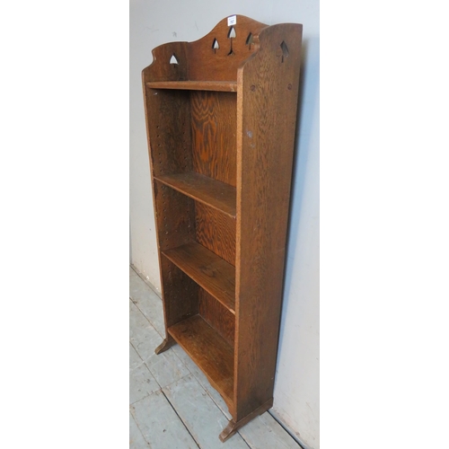 767 - An Arts & Crafts medium oak narrow open fronted bookcase, with carved & pierced decoration to top, h... 