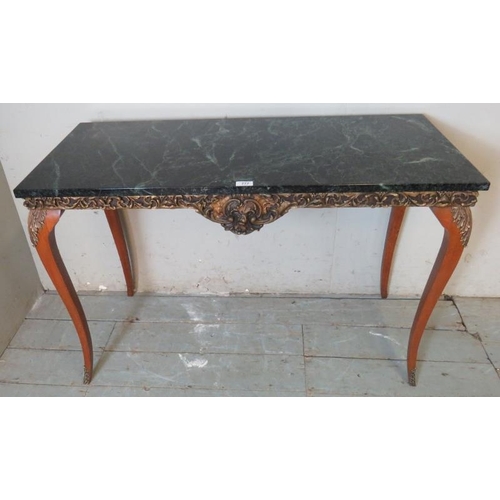 769 - A vintage black marble topped console table in the French taste, with ornately mould gesso frieze, r... 