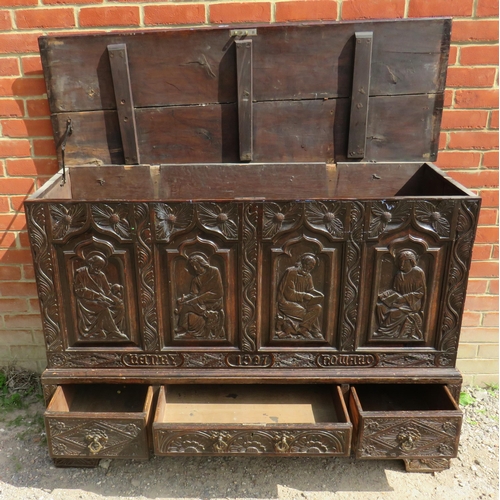 772 - A 19th century oak vestry chest ornately carved with ecclesiastical motifs, with three base drawers ... 