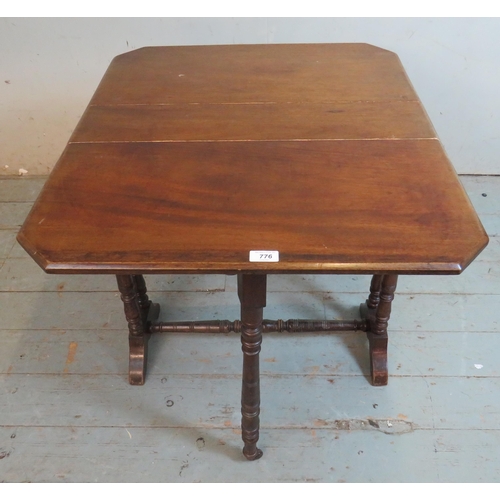 776 - An Edwardian mahogany octagonal Sutherland table raised on ring turned supports with outsplayed feet... 