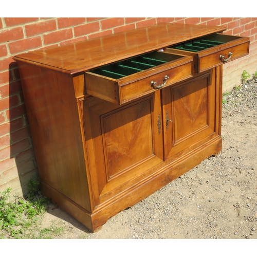 779 - A vintage French fruitwood sideboard with two cutlery drawers over twin cupboard doors opening onto ... 